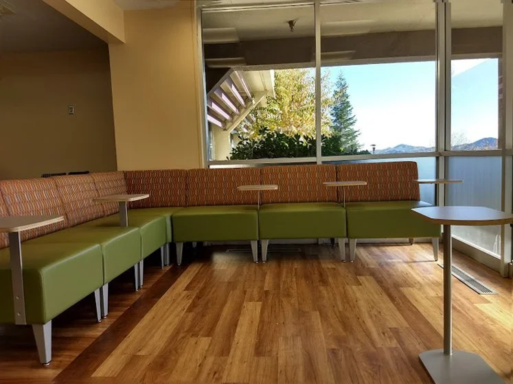 Commercial waiting area with modern banquette seating and mountain views