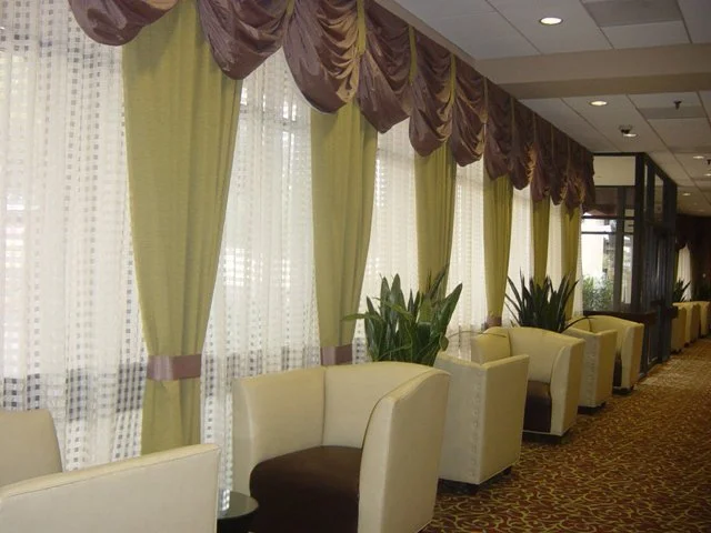 Hotel lobby corridor with custom drapery and upholstered seating