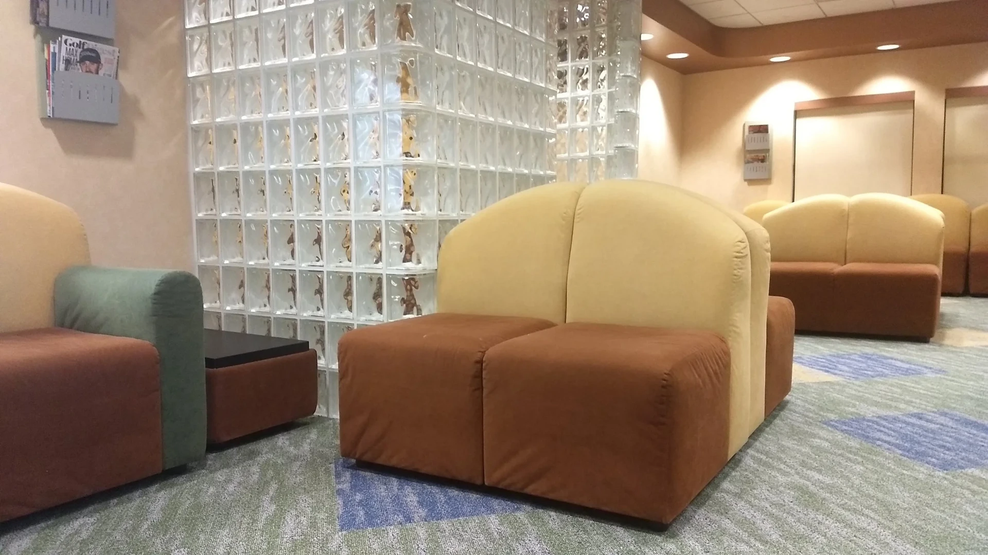 Pediatric waiting area with custom upholstered seating and glass block feature