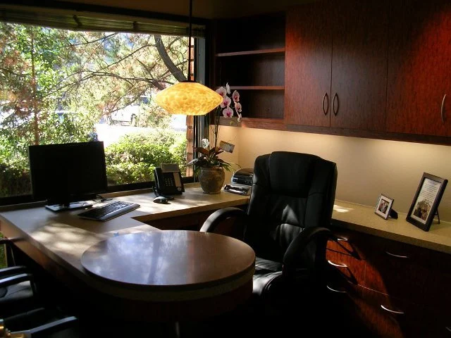 Executive hospitality office with cherry millwork and garden views